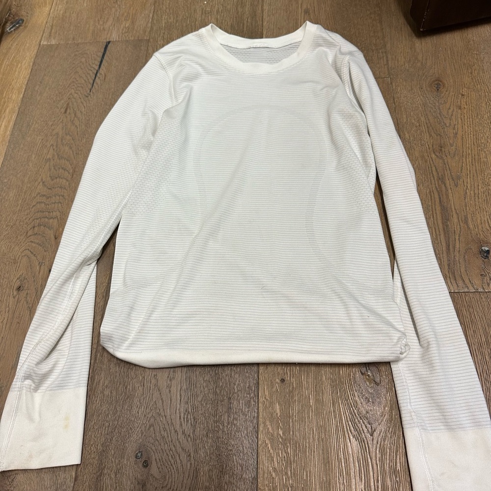 This is a white long sleeve swiftly tech from lululemon in a size 2